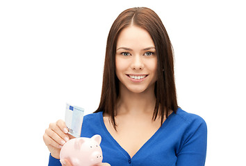 Image showing lovely woman with piggy bank and money