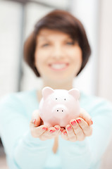 Image showing lovely woman with piggy bank