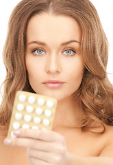 Image showing young beautiful woman with pills