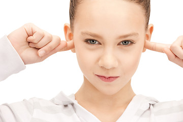 Image showing teenage girl with fingers in ears