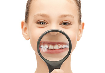 Image showing teenage girl with magnifying glass showing teeth