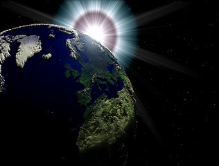 Image showing earth with displacement map and sun on the background