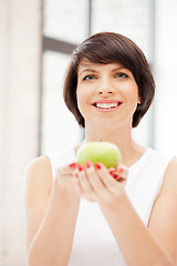 Image showing lovely housewife with green apple