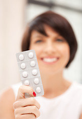 Image showing young beautiful woman with pills