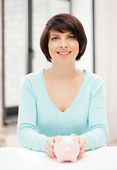 Image showing lovely woman with piggy bank