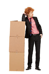 Image showing attractive businessman with big boxes