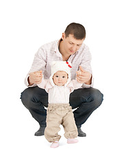 Image showing baby making first steps with father help