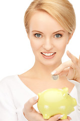 Image showing lovely woman with piggy bank and money