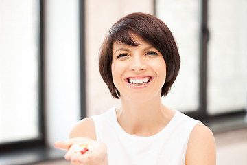 Image showing young beautiful woman with pills