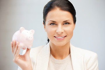 Image showing lovely woman with piggy bank