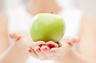 Image showing female hands with green apple