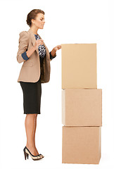Image showing attractive businesswoman with big boxes