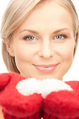 Image showing woman in mittens with snow