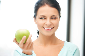 Image showing lovely housewife with green apple