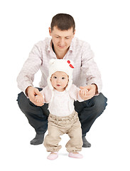 Image showing baby making first steps with father help