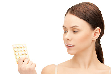 Image showing young beautiful woman with pills