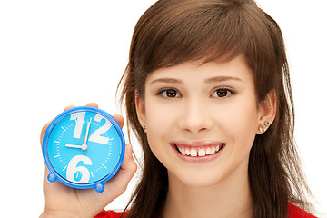 Image showing teenage girl holding alarm clock