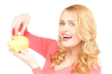 Image showing lovely woman with piggy bank and money