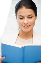 Image showing happy and smiling woman with book