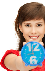 Image showing teenage girl holding alarm clock