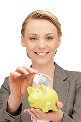 Image showing lovely woman with piggy bank and money