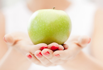 Image showing female hands with green apple