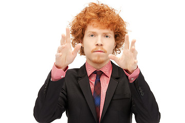 Image showing businessman working with something imaginary