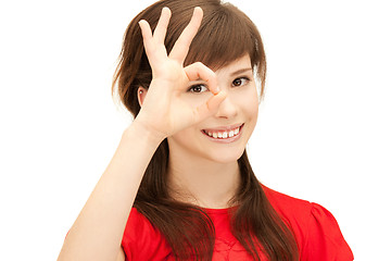 Image showing teenage girl looking through hole from fingers