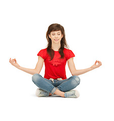 Image showing happy and carefree teenage girl in lotus pose