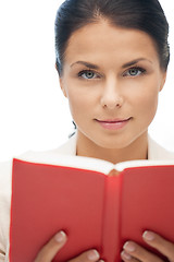 Image showing calm and serious woman with book