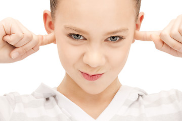 Image showing teenage girl with fingers in ears
