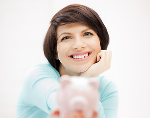 Image showing lovely woman with piggy bank