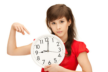 Image showing teenage girl holding big clock