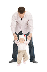 Image showing baby making first steps with father help