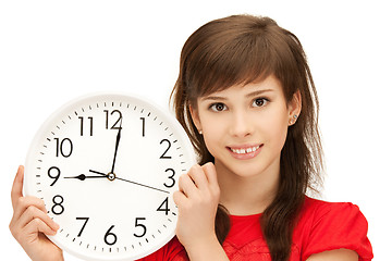 Image showing teenage girl holding big clock