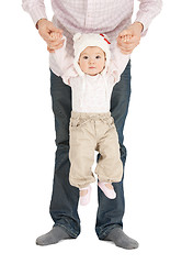 Image showing baby hanging on fathers hands