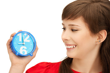 Image showing teenage girl holding alarm clock