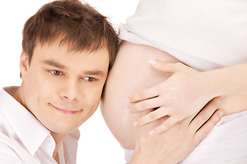 Image showing male face and pregnant woman belly