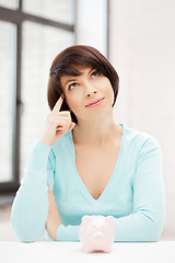 Image showing lovely woman with piggy bank