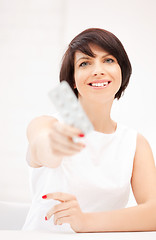 Image showing young beautiful woman with pills