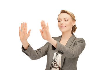 Image showing businesswoman working with something imaginary