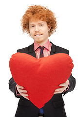 Image showing handsome man with red heart-shaped pillow