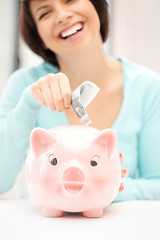 Image showing lovely woman with piggy bank and money