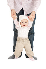 Image showing baby making first steps with father help