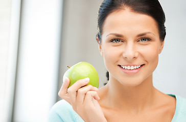 Image showing lovely housewife with green apple