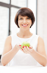 Image showing lovely housewife with green apple