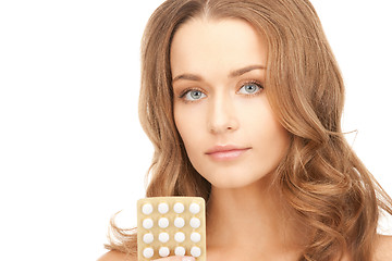 Image showing young beautiful woman with pills