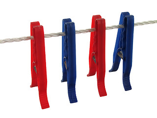 Image showing Blue and red clothespins on a clothes line (+ clipping path)