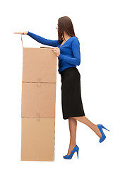 Image showing attractive businesswoman with big boxes