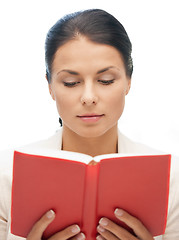 Image showing calm and serious woman with book